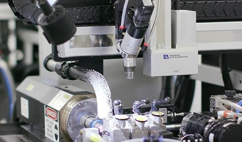 See Reasons robotic engineers are one of the top paying engineering jobs in UK. Close-up of an industrial robotic arm spraying material in a manufacturing setting, demonstrating automated systems designed by robotics engineers.