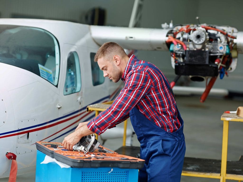 an Aerospace Engineer working on an aircraft. see what make Aerospace engineering one of the high salary engineering jobs in the USA