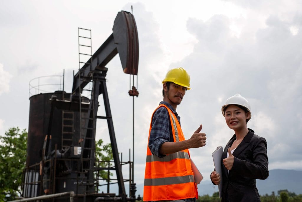 Petroleum Engineers working on an oil pump, Petroleum Engineering is one of the high paying engineering jobs in the United States